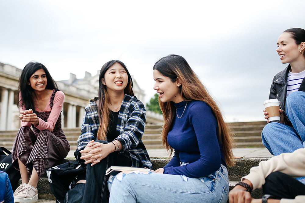 4 students sitting on stairs