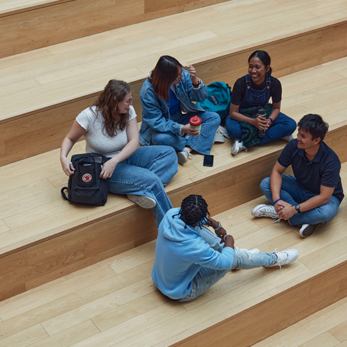 4 students sitting on stairs